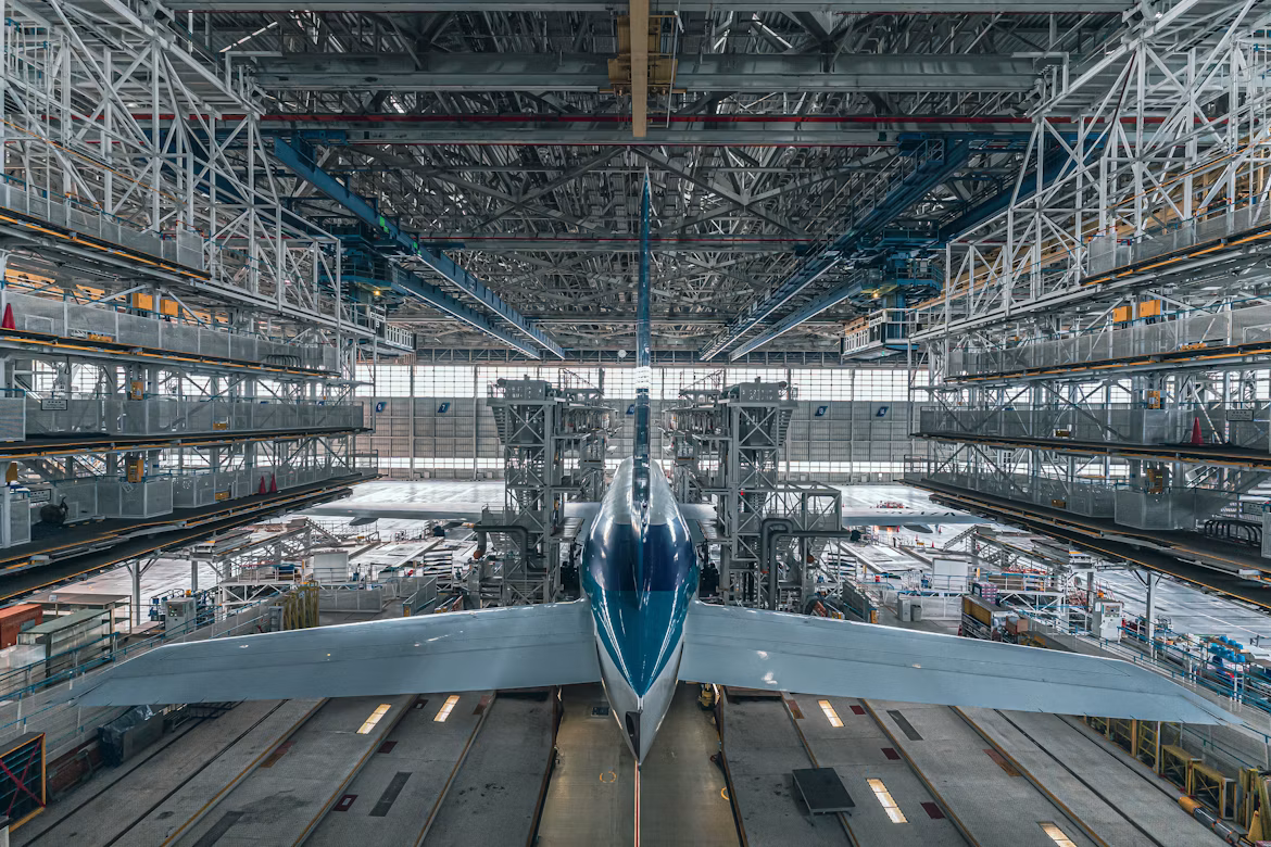 Aircraft nose-on inside an assembly hangar